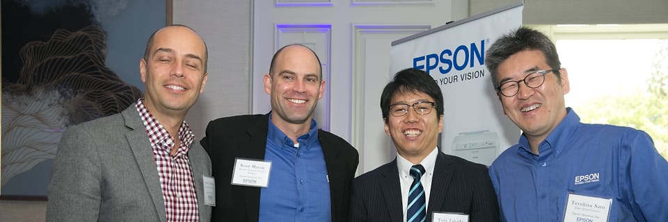 Four colleagues in business clothes at an on-site corporate event