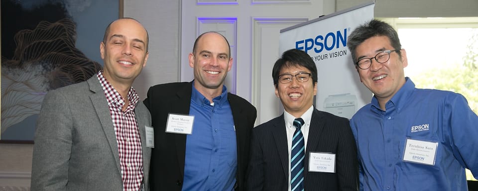 Four colleagues in business clothes at an on-site corporate event