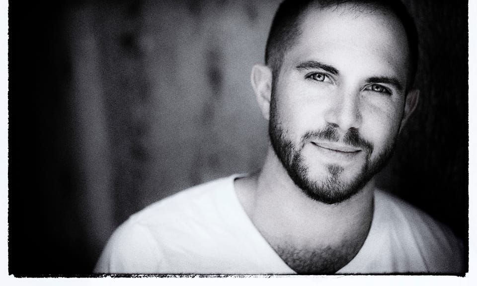 Black and white actor headshot of Jesse Rosen with a film-border finish