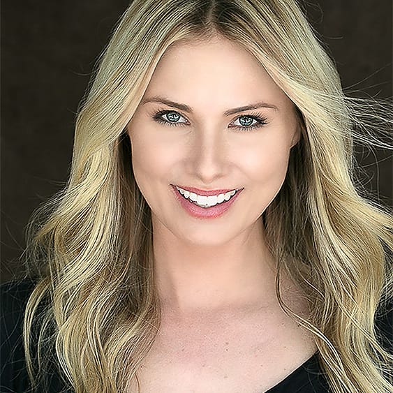 Actor-style beauty headshot of a blonde woman in a black v-neck