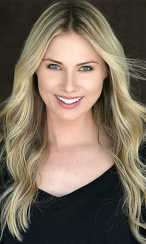 Actor-style beauty headshot of a blonde woman in a black v-neck