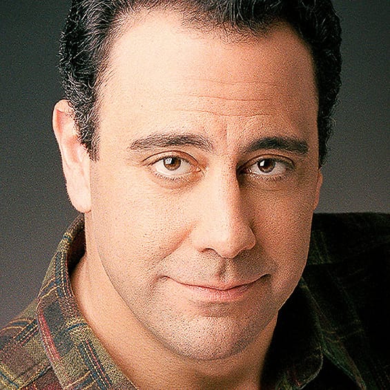 Character actor portrait of a man in a plaid shirt with a held expression