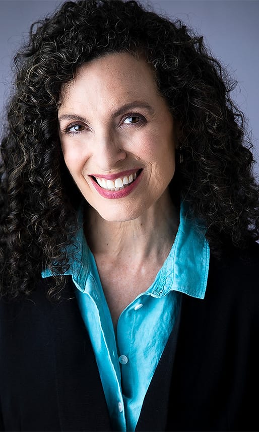 Creative professional portrait of a woman in a turquoise shirt and black blazer