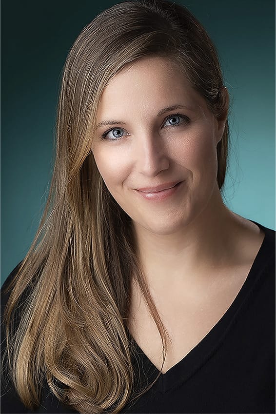 Studio branding portrait of a woman on a teal background