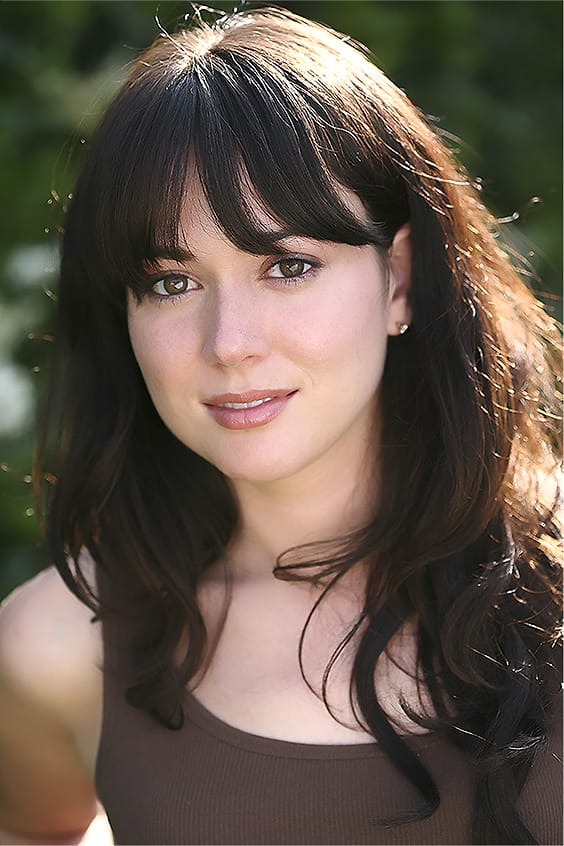Natural-light actor portrait of a woman with bangs photographed outdoors