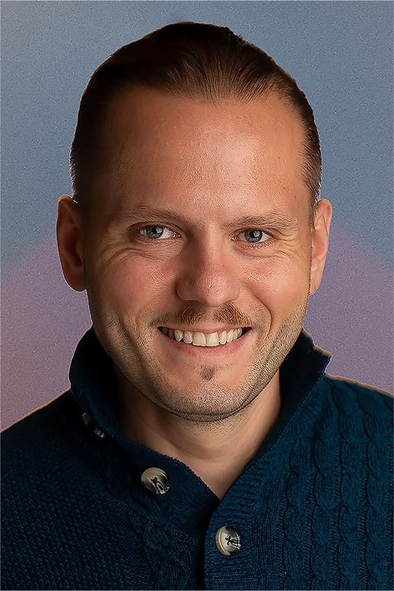 Personal branding portrait of a man in a teal cable-knit sweater