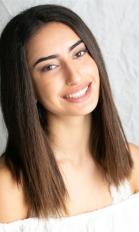 Editorial actor portrait of a young woman in an off-shoulder white top