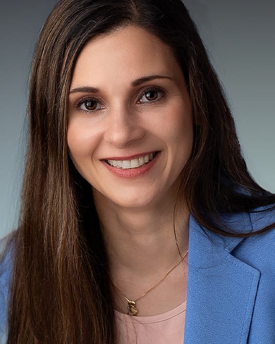 Business headshot of a woman in a blue blazer