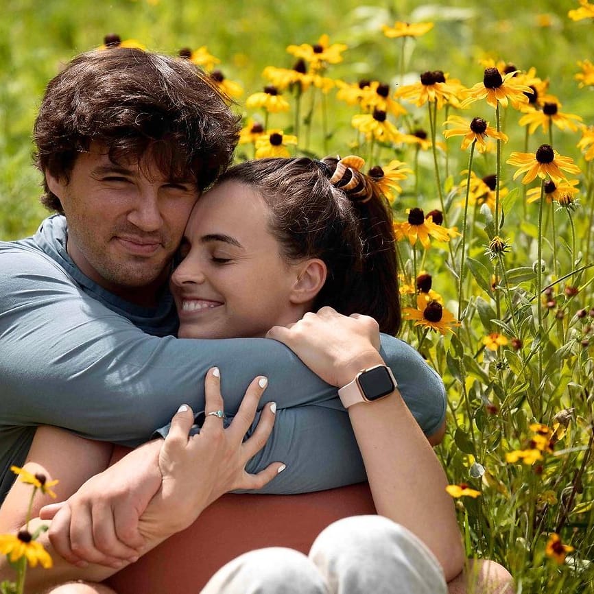 Color outdoor couple portrait in a field of black-eyed Susans in Asheville